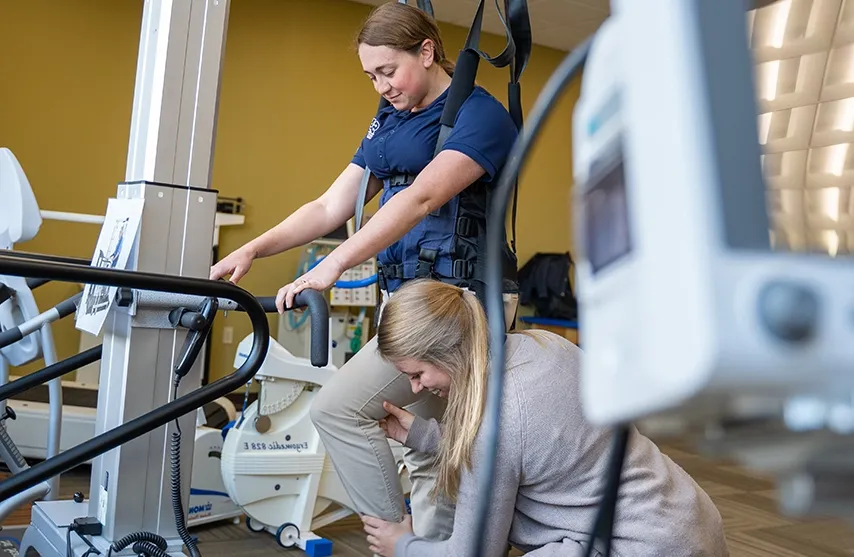 Two students practice phyiscal therapy techniques.