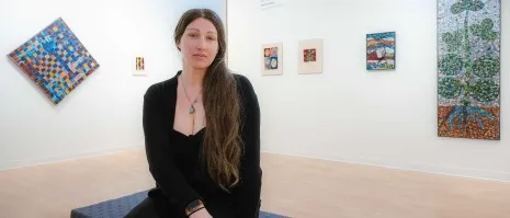 A woman sitting in an art gallery.